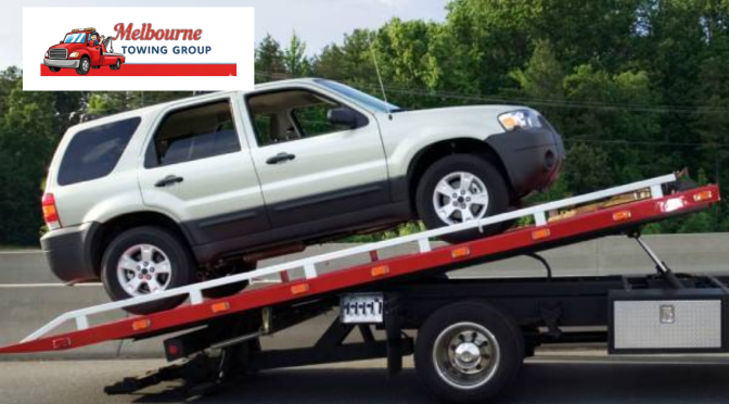 Heavy-duty truck towing service recovering a broken-down commercial truck on the highway.